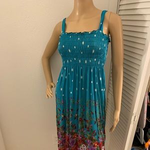 Turquoise sun dress. Size small/medium. Brand new with tags. Flower detail.